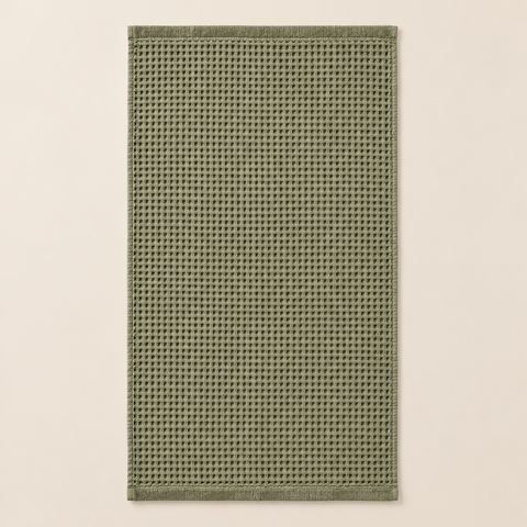 Lot de 2 serviettes de bain en nid d’abeille dépliée sur fond beige